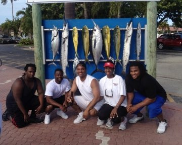 Group of people in front of the sailfish marina sign